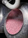 Coating pink jelly beans with sugar and syrup in panning department