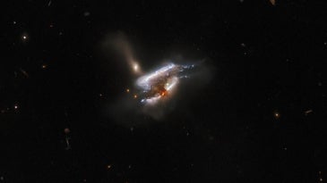 Three galaxies forming a gassy swirl in a Hubble Space Telescope image