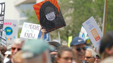 Climate change protest poster with COVID mask