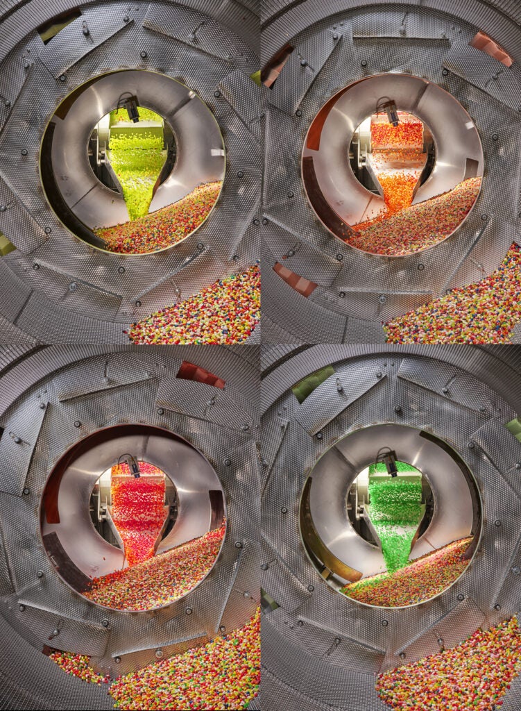Four view of the Jelly Belly factory tumblers with yellow, orange, green, and red beans clockwise from top left