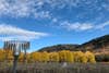 A weather station in front of a Utah mountain range dotted with yellow aspen trees