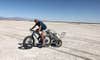 Elderly scientist hauls dust-measuring instruments on fat-tire bike across the Great Salt Lake