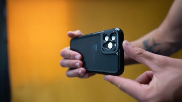 A person holding a phone horizontally and filming a video.