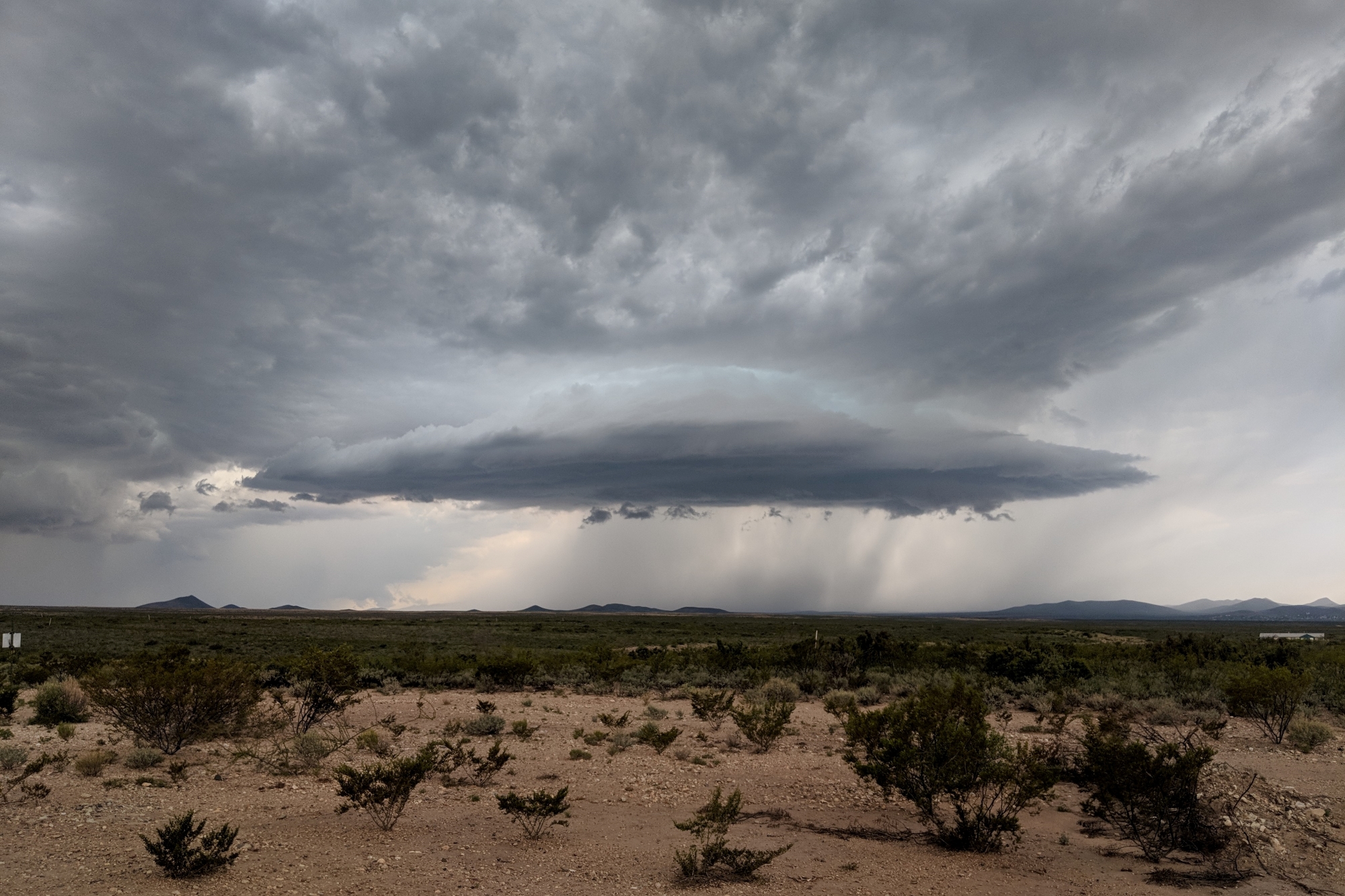 A storm cloud brought by the North American monsoon hangs over the desert near Tombstone, Arizona.