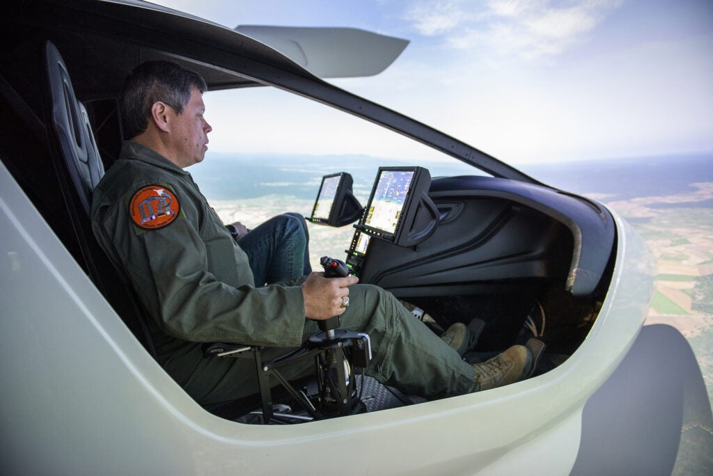Griffiths in a simulator, with the aircraft's control stick in his right hand.