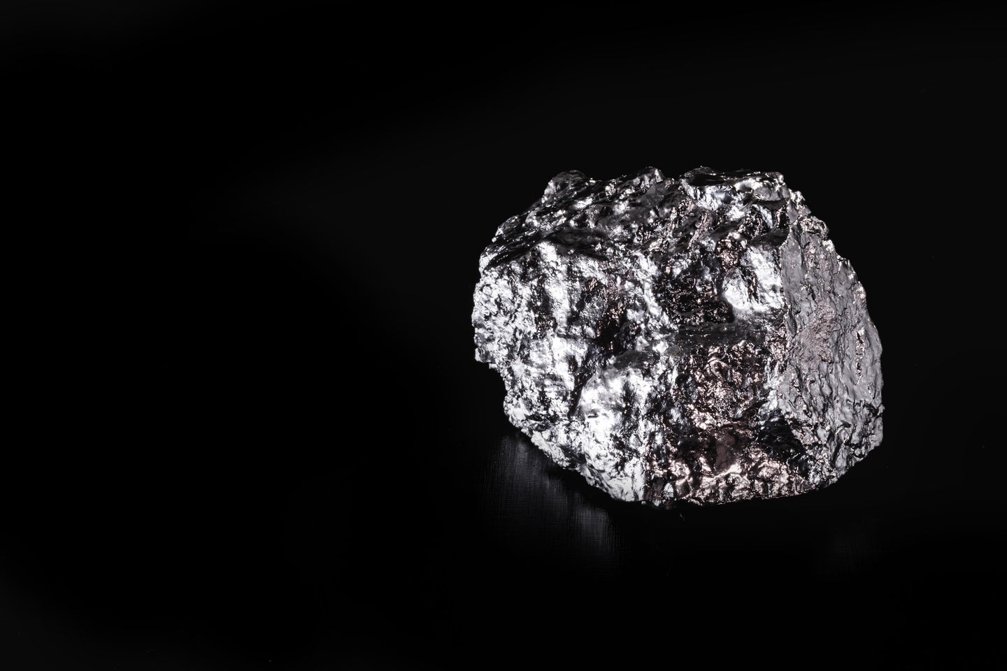 Rare platinum ore nugget on a black background