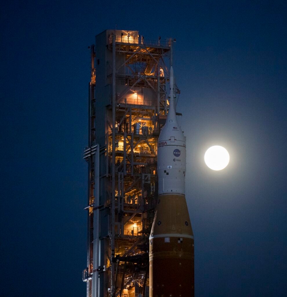 Full moon behind the NASA SLS rocket on the launchpad at Kennedy Space Center in Florida