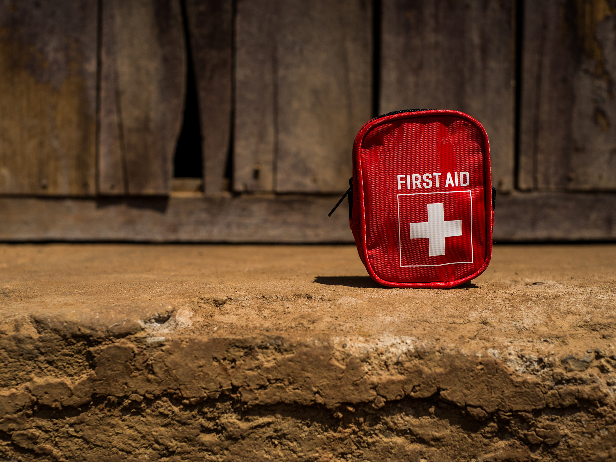 First aid kit bag on the ground.