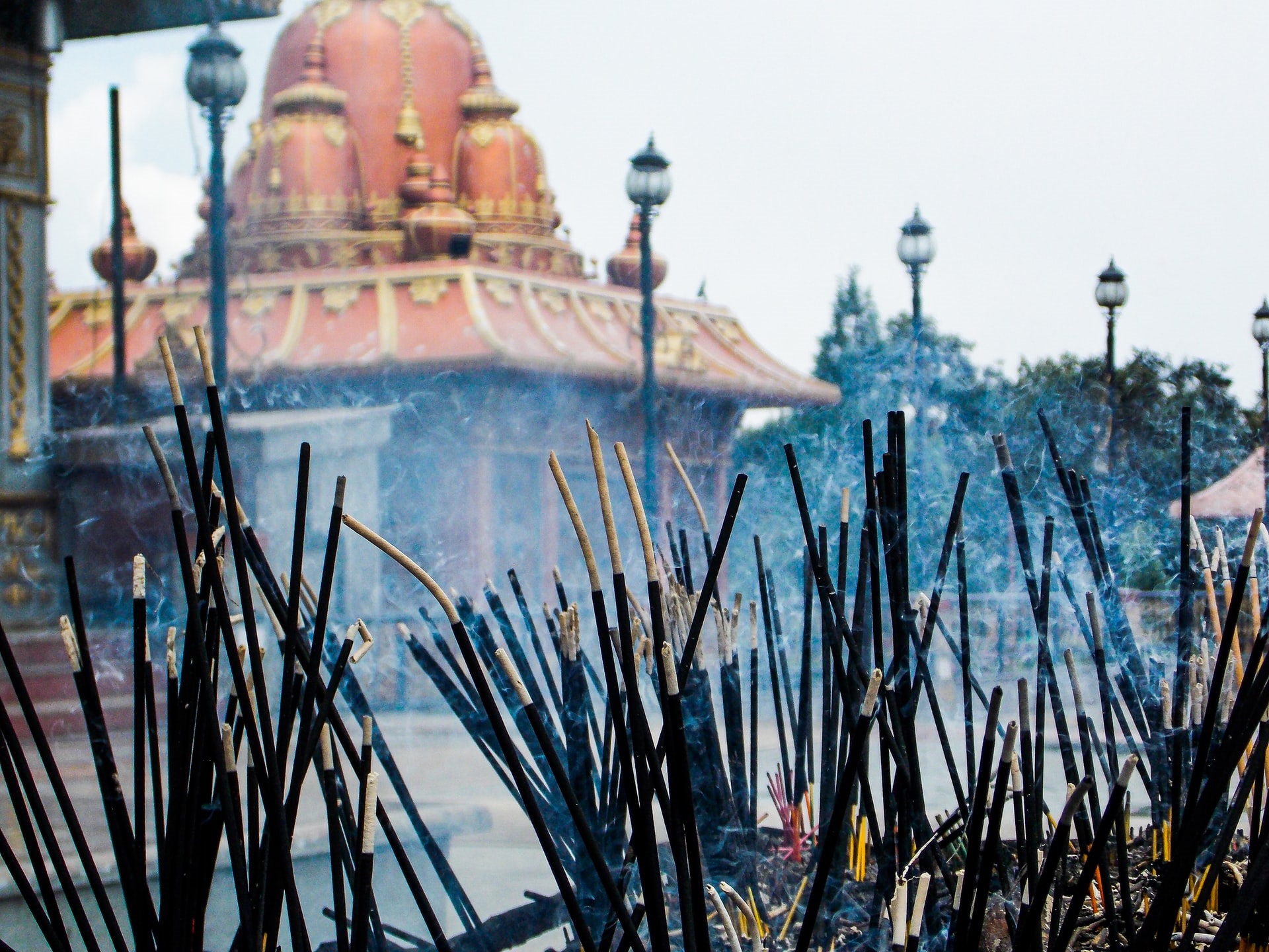 Incense burning with ancient smells in front of a Buddhist temple