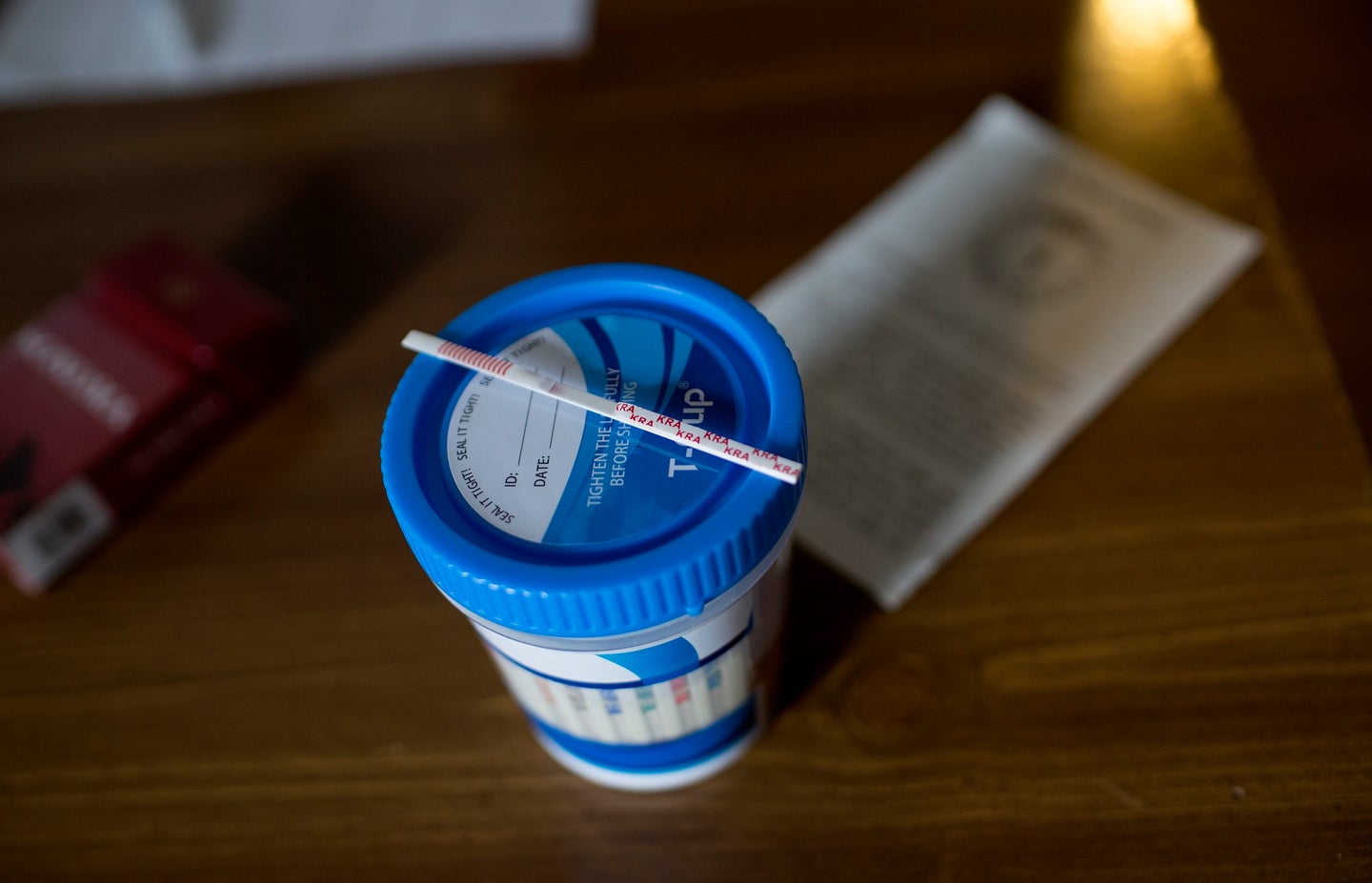 Fentanyl test trip over blue sample container to prevent overdoses in the opioid crisis