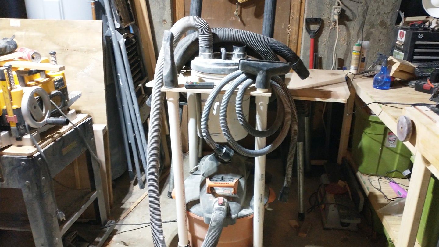 A DIY shop vac-mounted dust collector in a basement workshop.