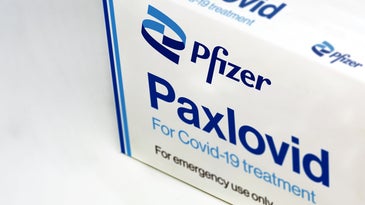 a white and blue medicine box that reads paxlovid by pfizer