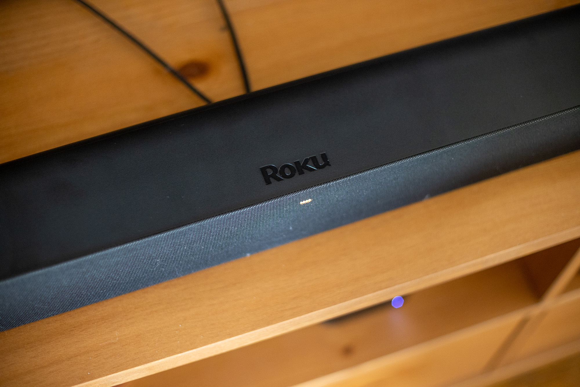 Stan's Roku Stream bar Pro sitting on a brown cabinet