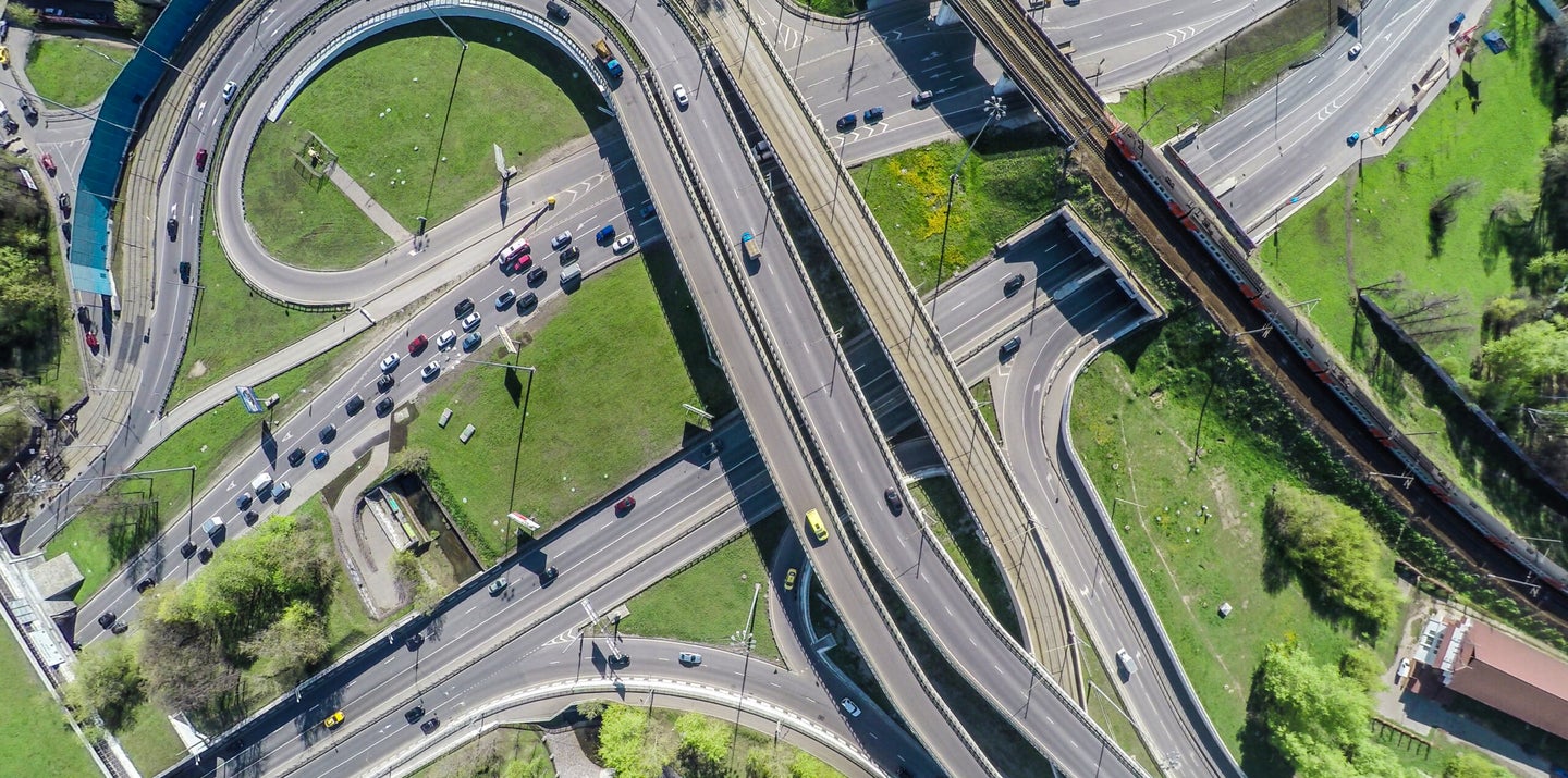 Aerial view of a highway interchange with cars congested on one side.