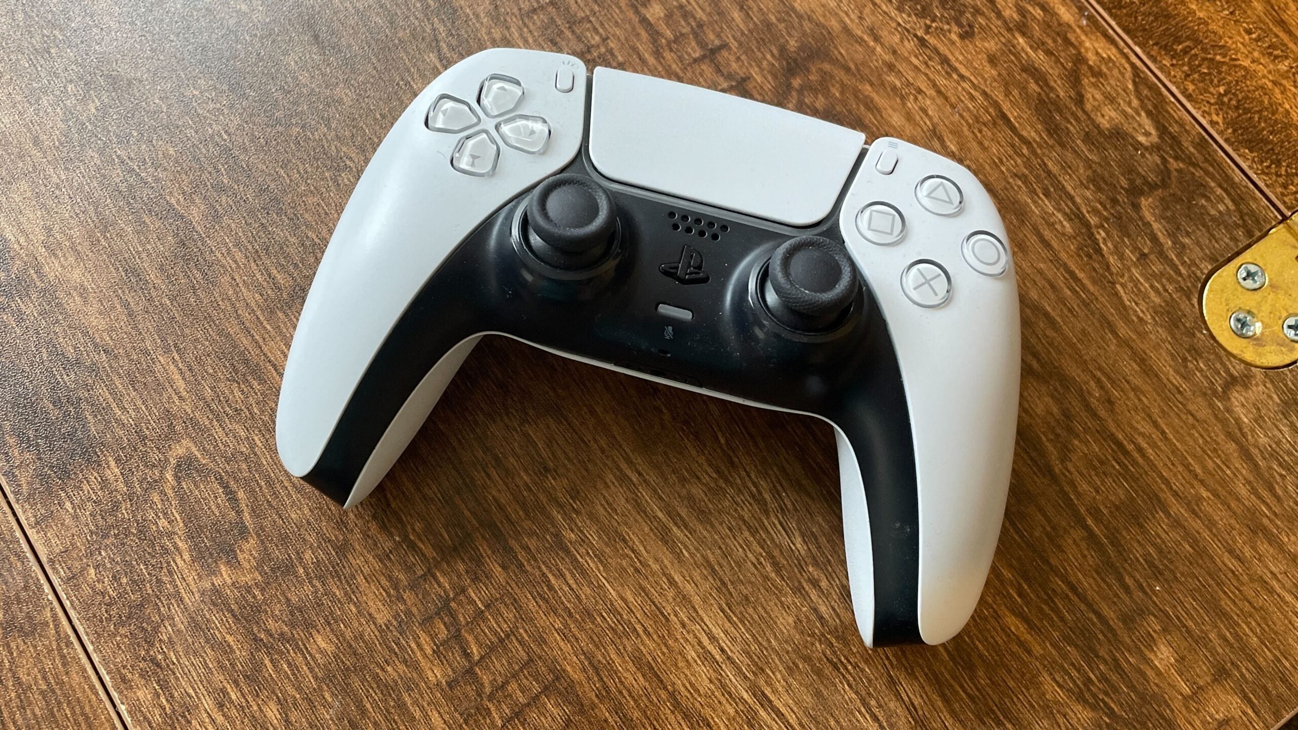 Playstation Dualsense Controller on a wood surface