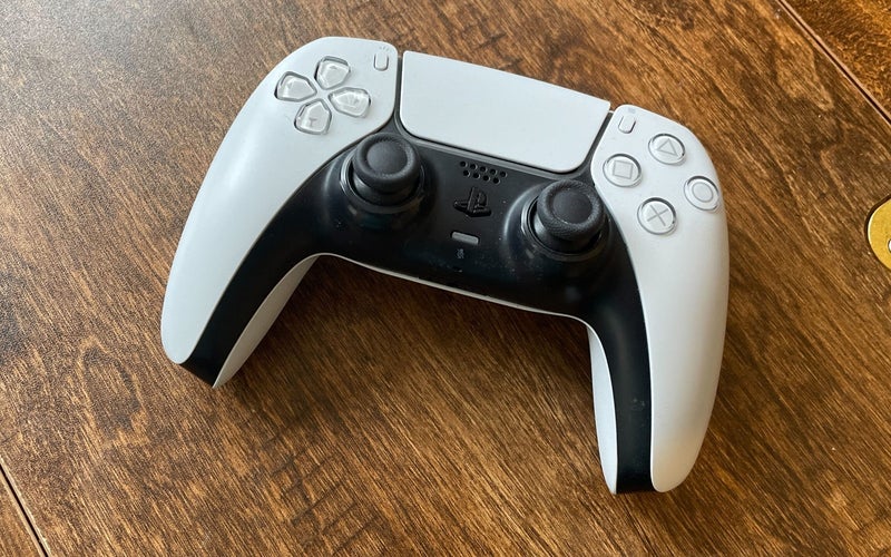 Playstation Dualsense Controller on a wood surface