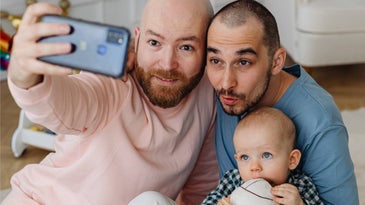 couple with baby taking selfie