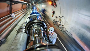 CERN worker examining semiconducting magnets of Large Hardon Collider accelerator