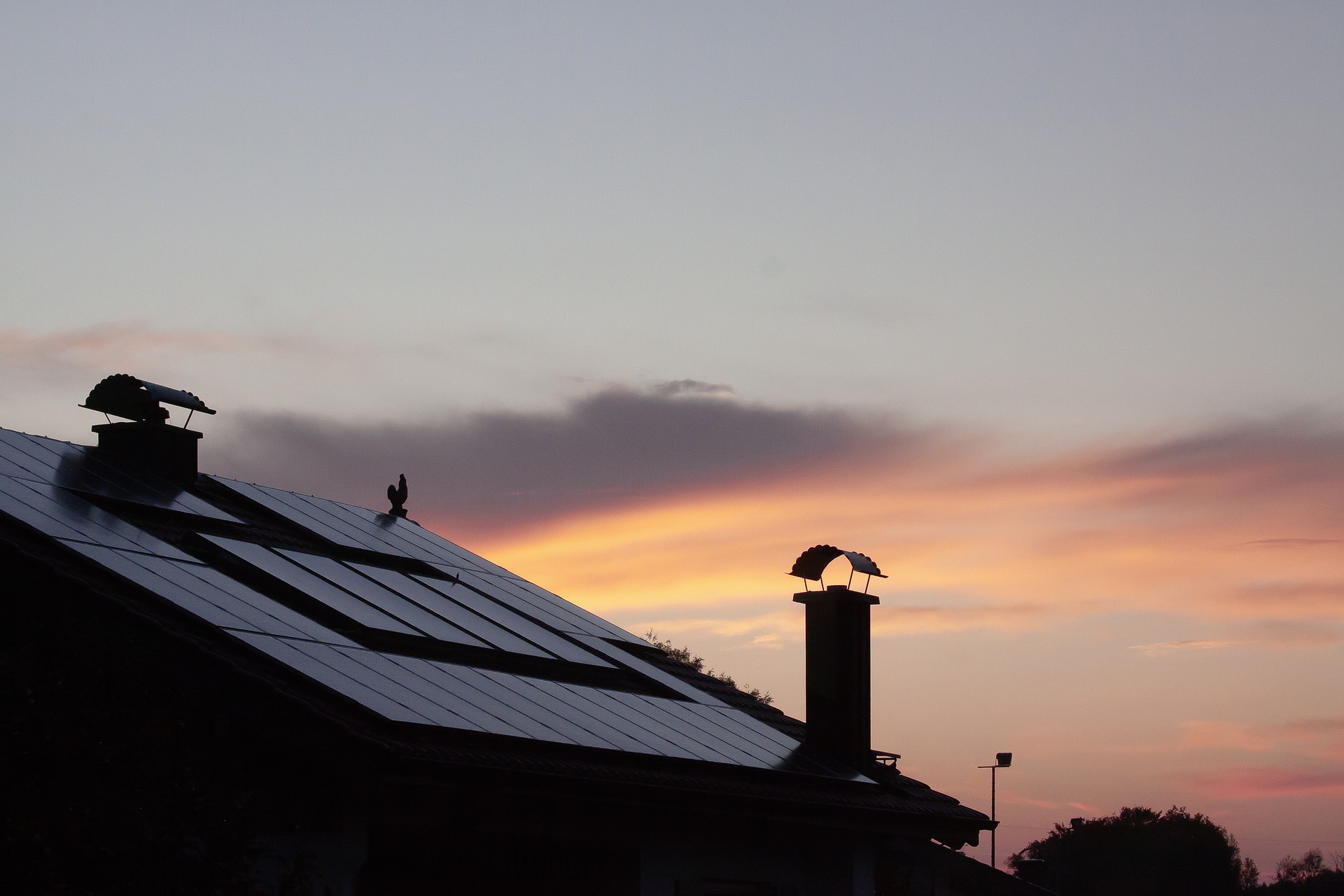 Solar panels on a home's roof at sunrise.