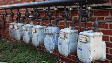 Gas meters on brick wall.