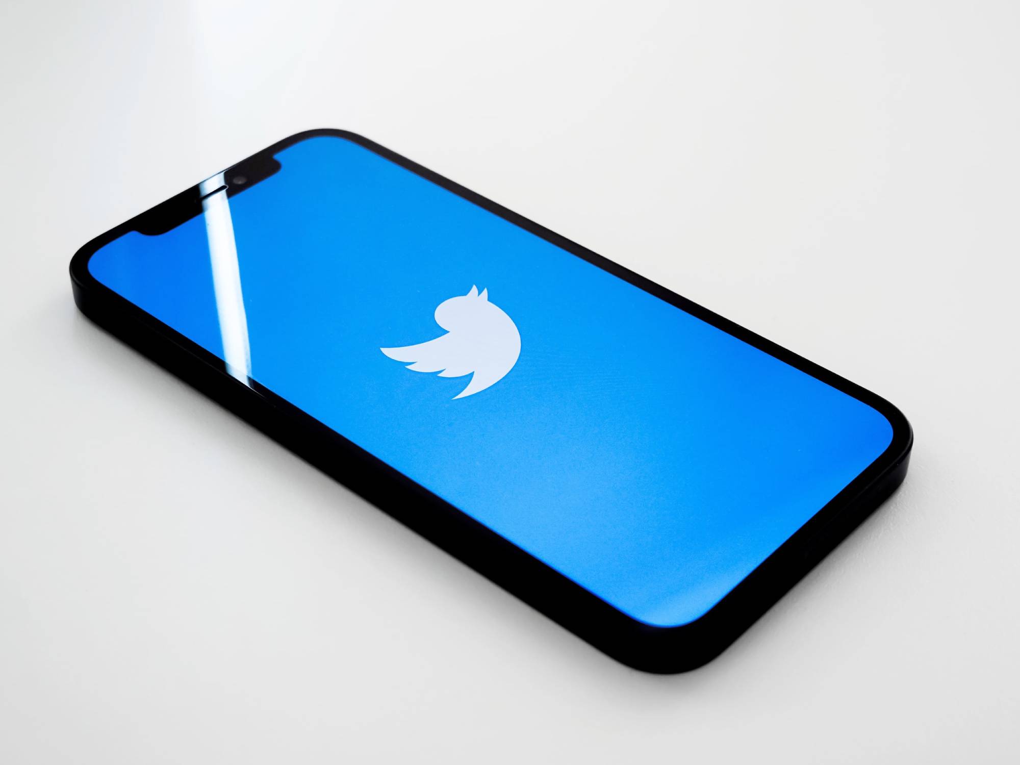 phone on desk showing twitter icon