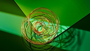 Ball of copper wire on green background