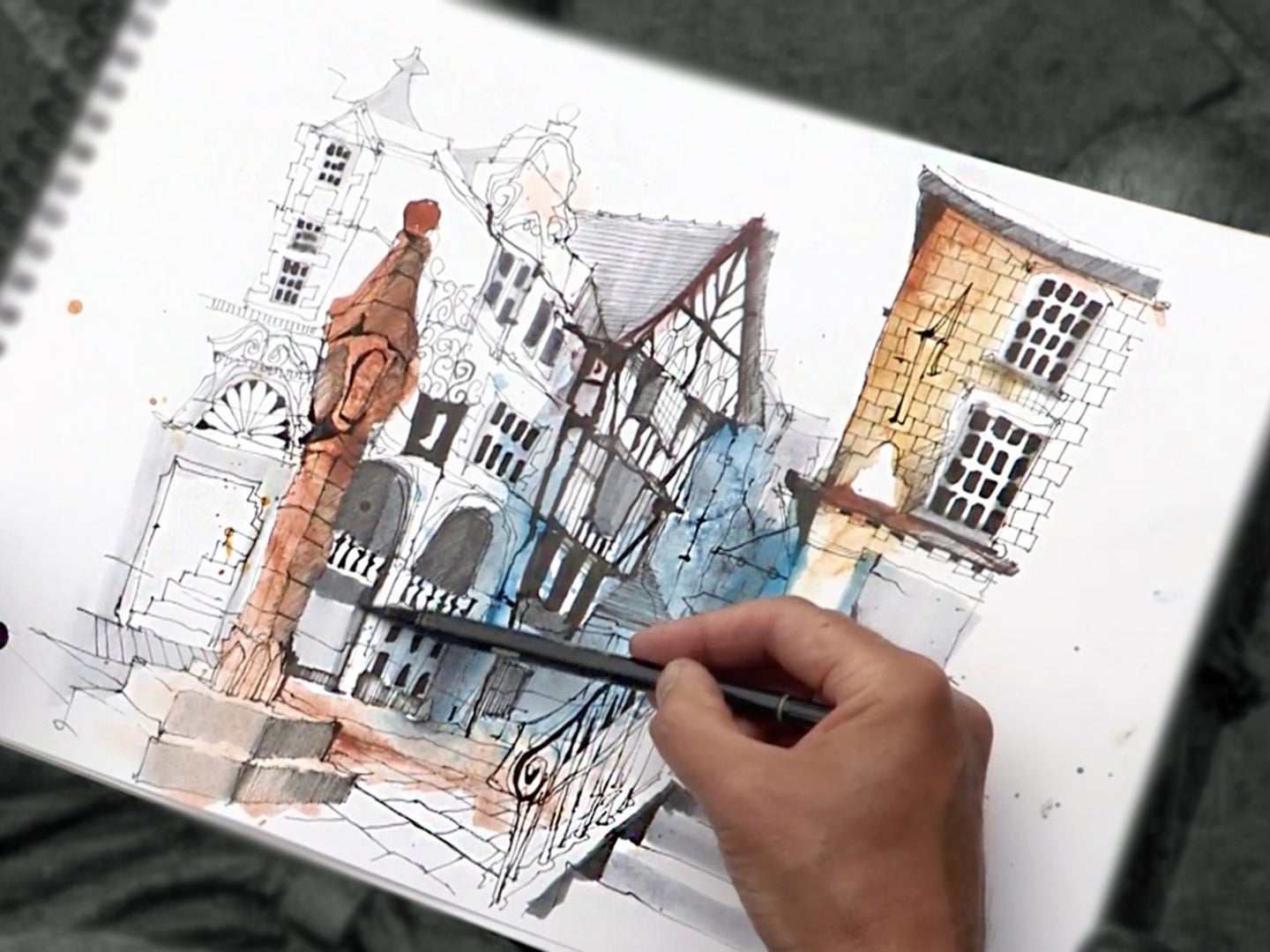 person sketching a cityscape