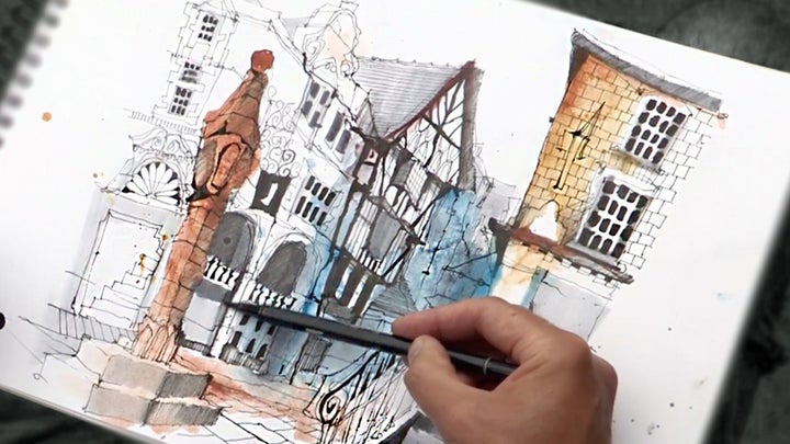 person sketching a cityscape