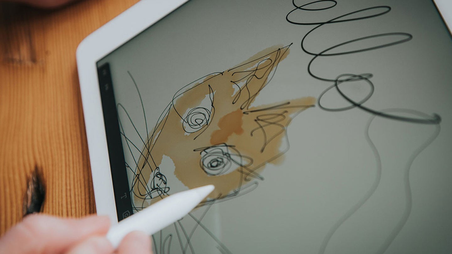 child drawing on an iPad