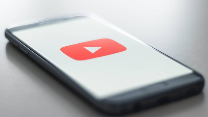 Smartphone-on-desk-with-youtube-logo-on-screen