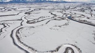 An aerial view of meandering frozen channels of the Copper River in Alaska.