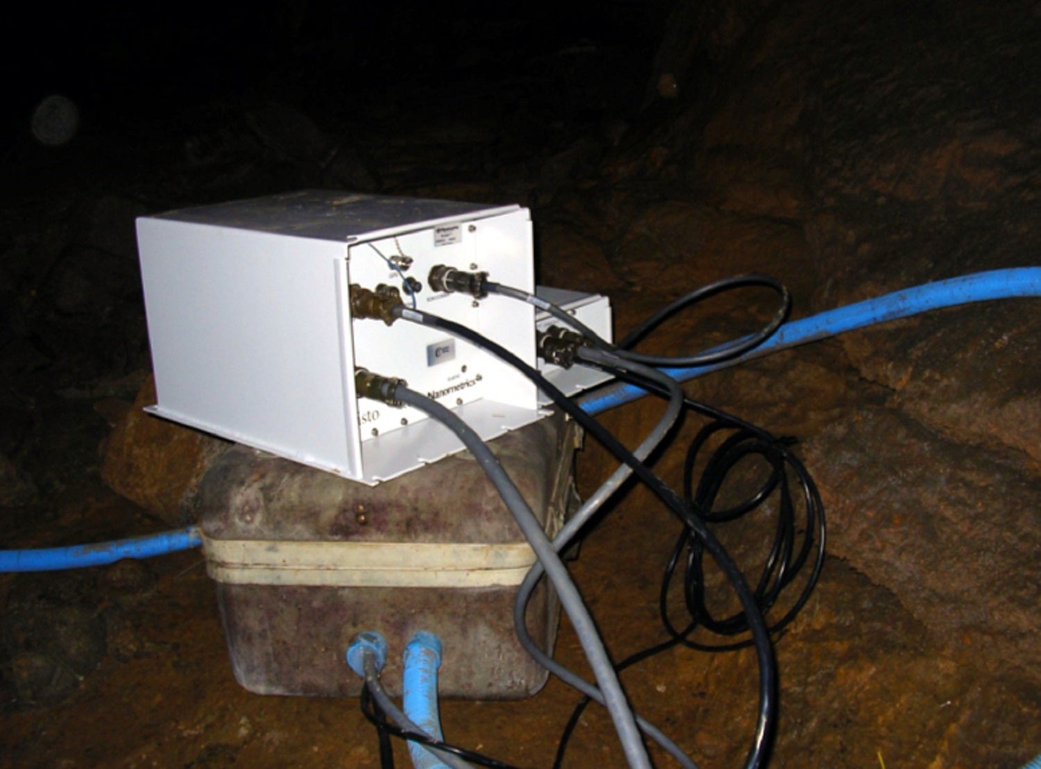 White seismograph connected to black and blue wires in Tuckaleechee Caverns