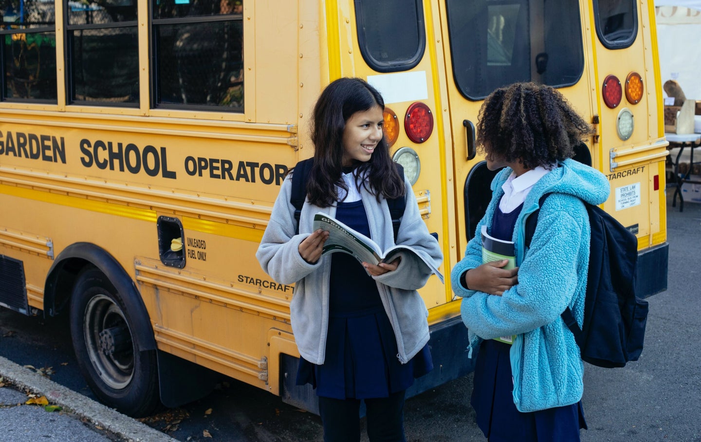 Children standing by school bus