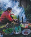 Chef and author Alice Waters cooks food outdoors in her garden in her backyard.