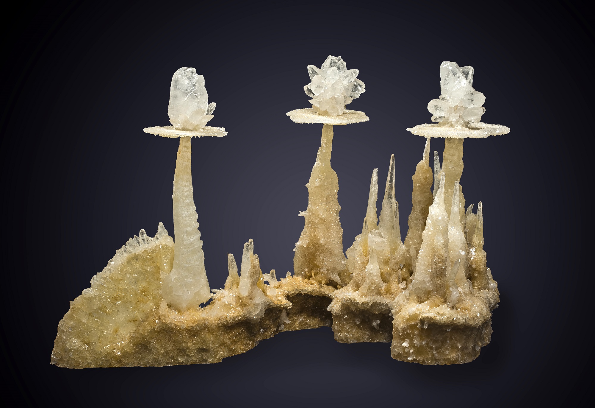 Stacks of white calcite on a black background in a mineral catalog