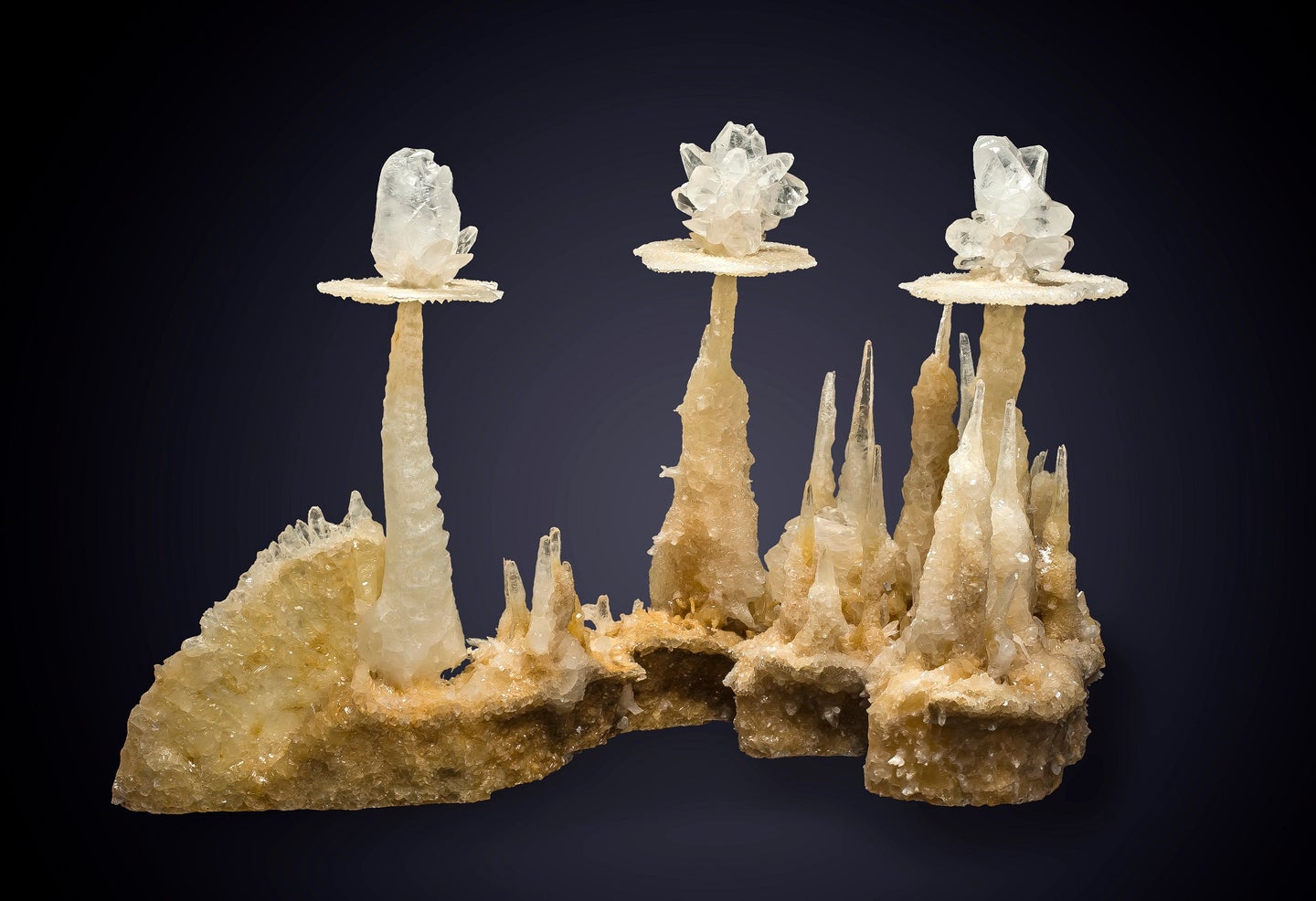 Stacks of white calcite on a black background in a mineral catalog