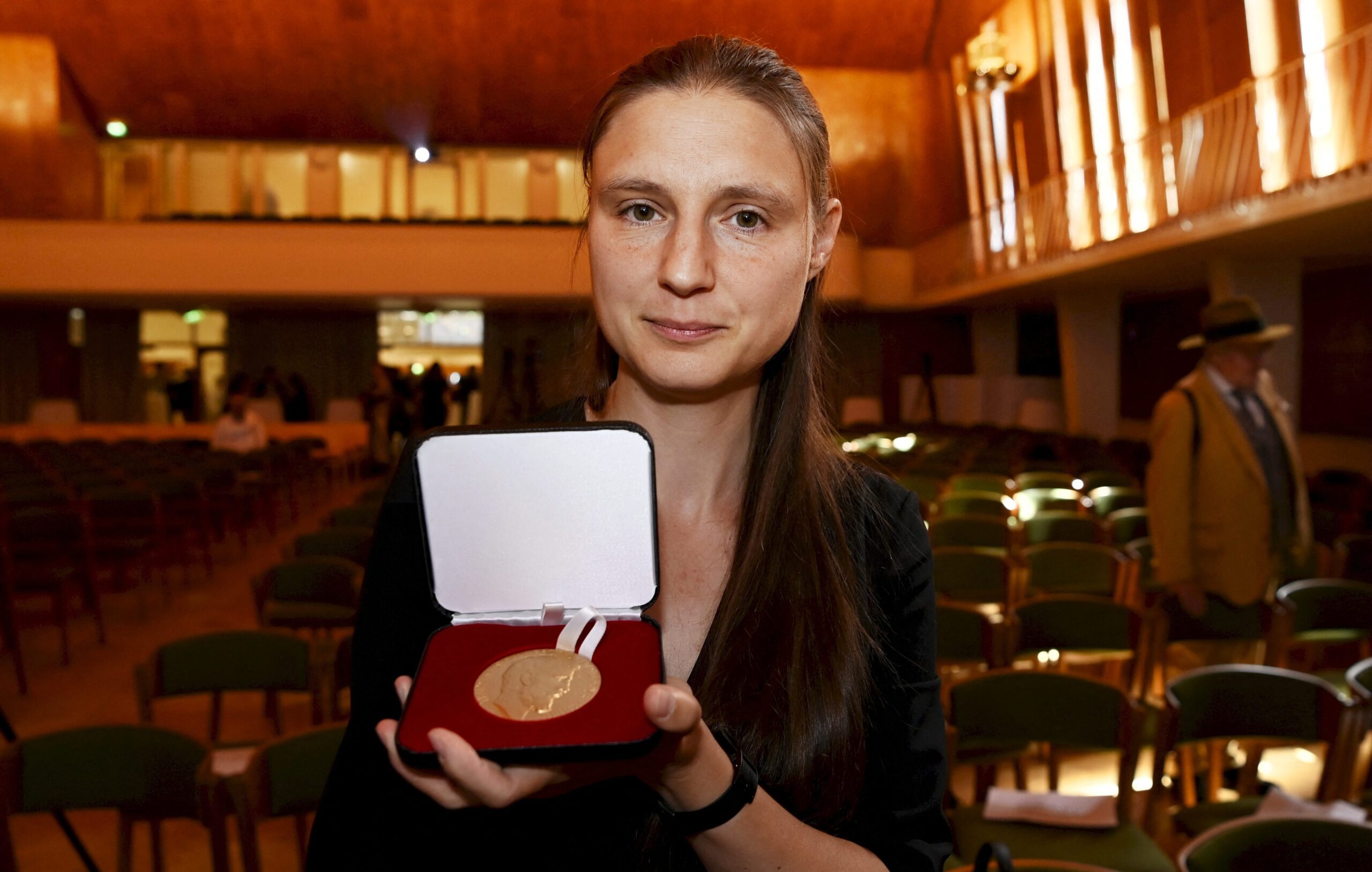 Ukraine's Maryna Viazovska holding her Fields Medal.