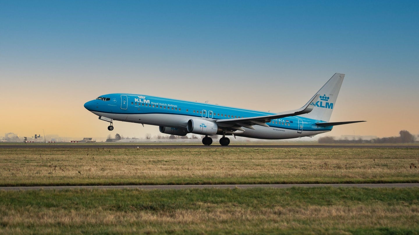 KLM airplane taking off of runway.