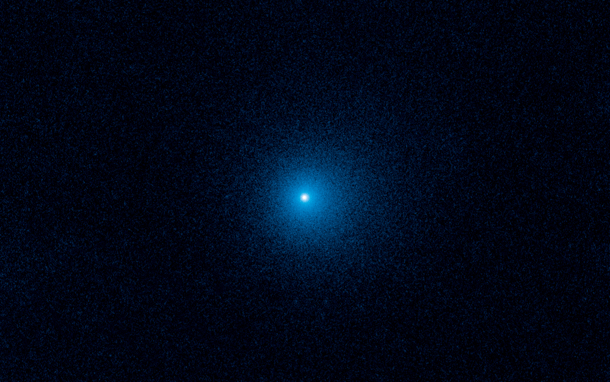 K2 comet looking like a blue dot in the black vastness of the solar system before its Earth flyby