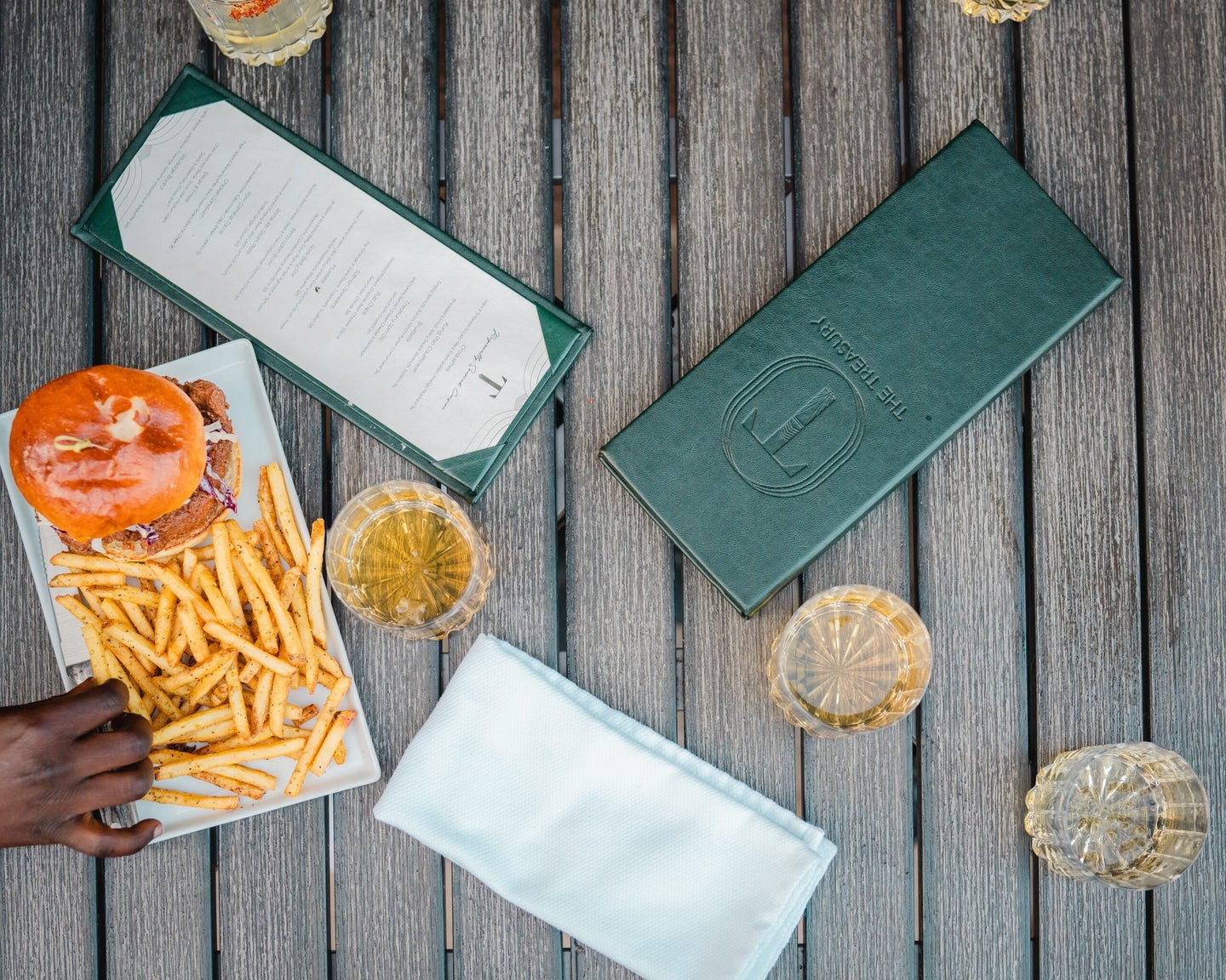 French fries and food menus on dining table.