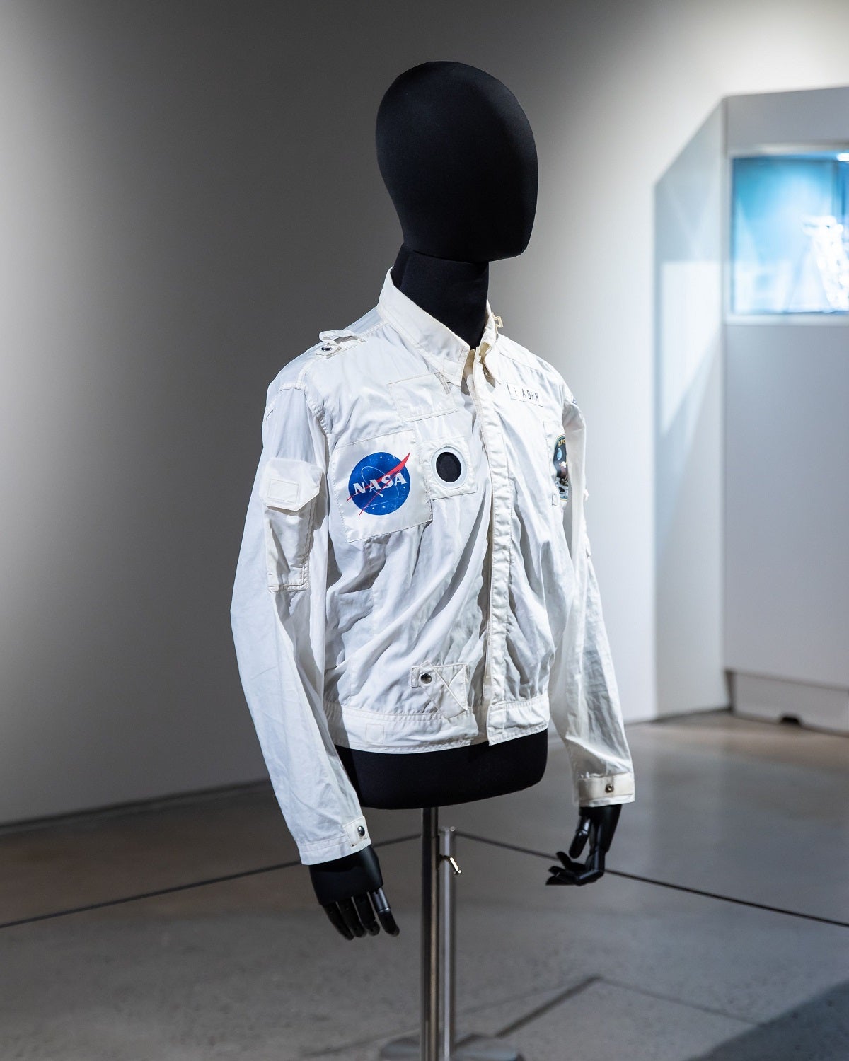White NASA Apollo 11 flight jacket on a black mannequin