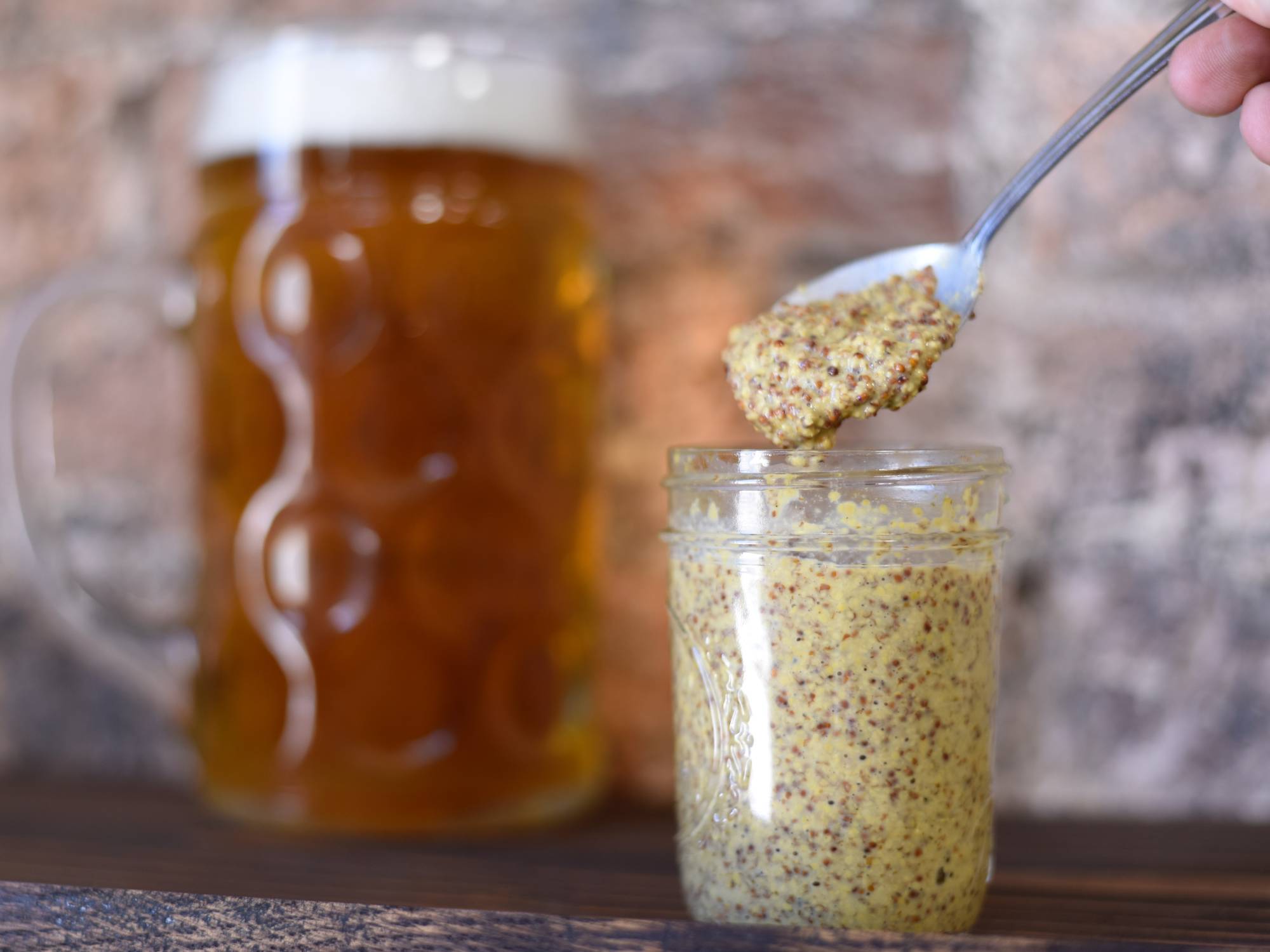jar of mustard with pitcher of beer in the background