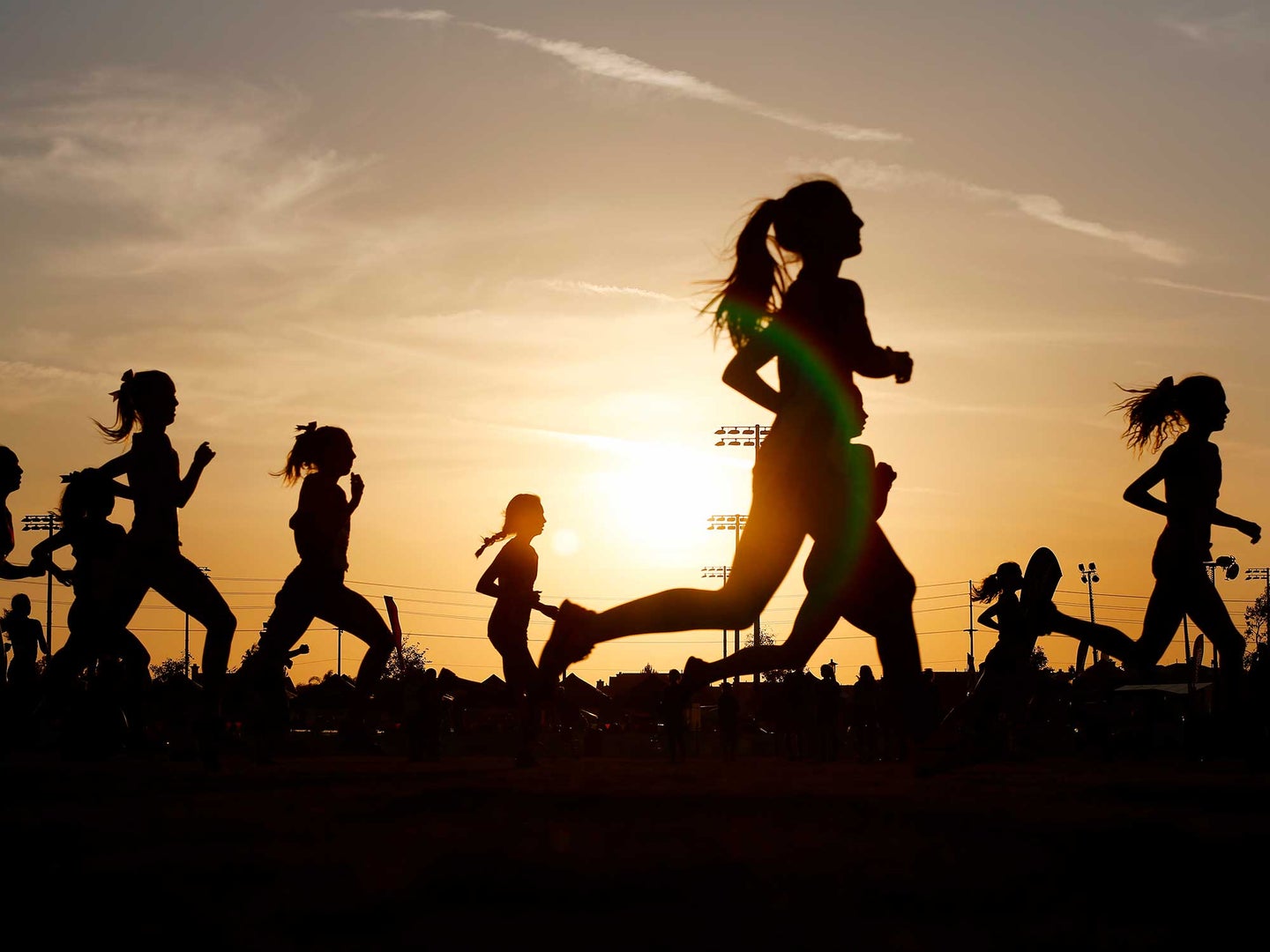 Children running a race at sunset