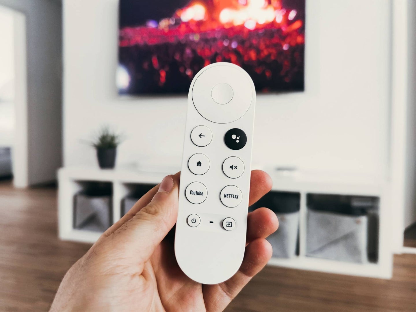 Hand holding a google tv remote