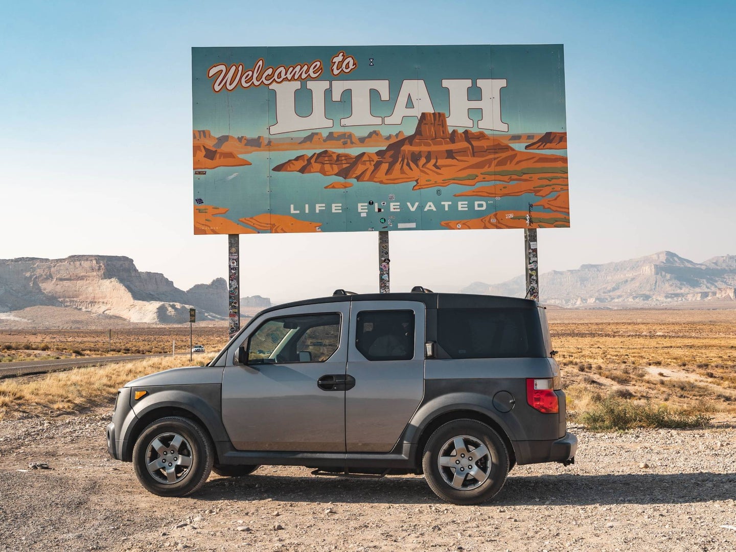 honda element suv in front of welcome to utah sign