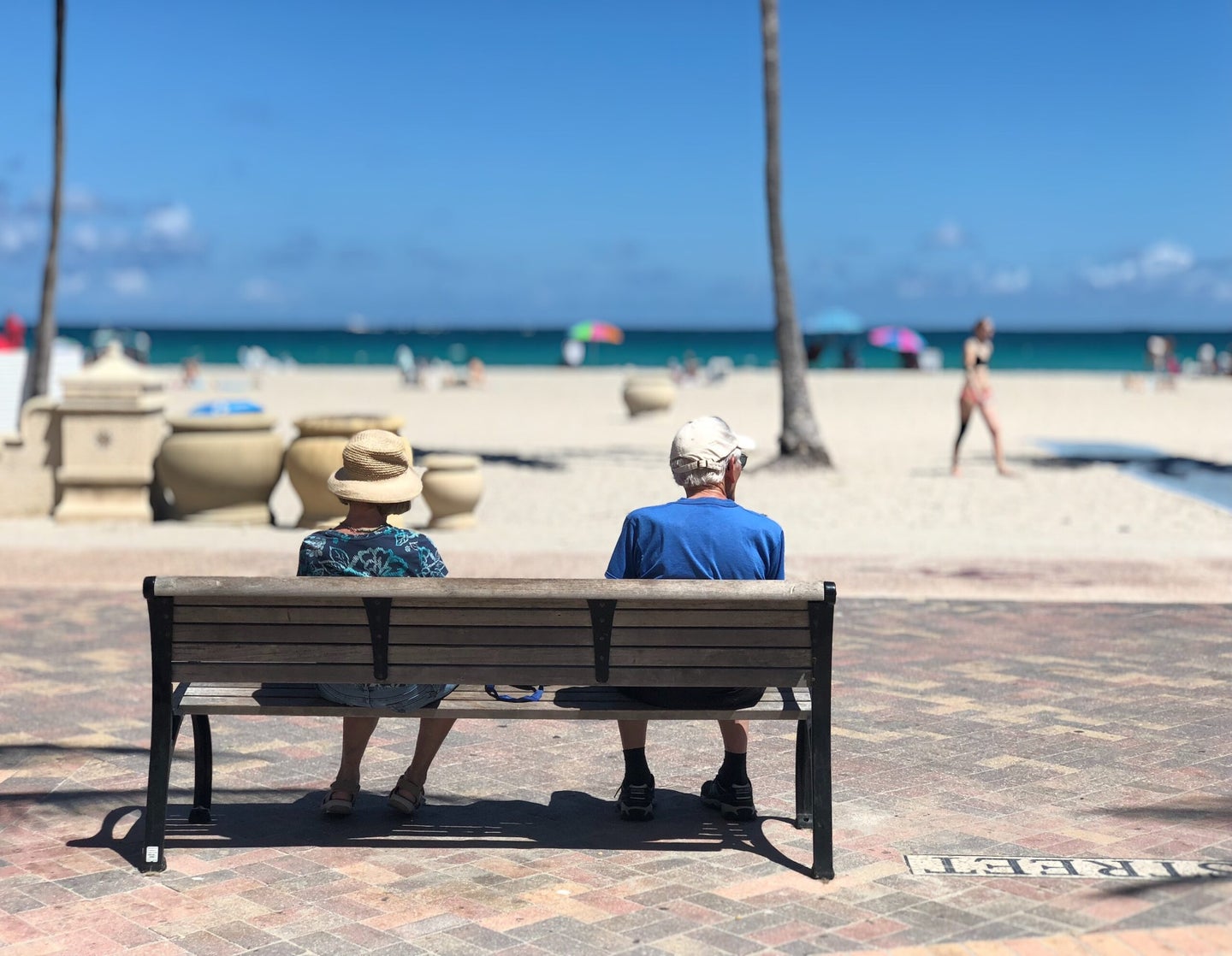 Older couple sitting on bench in Miami.