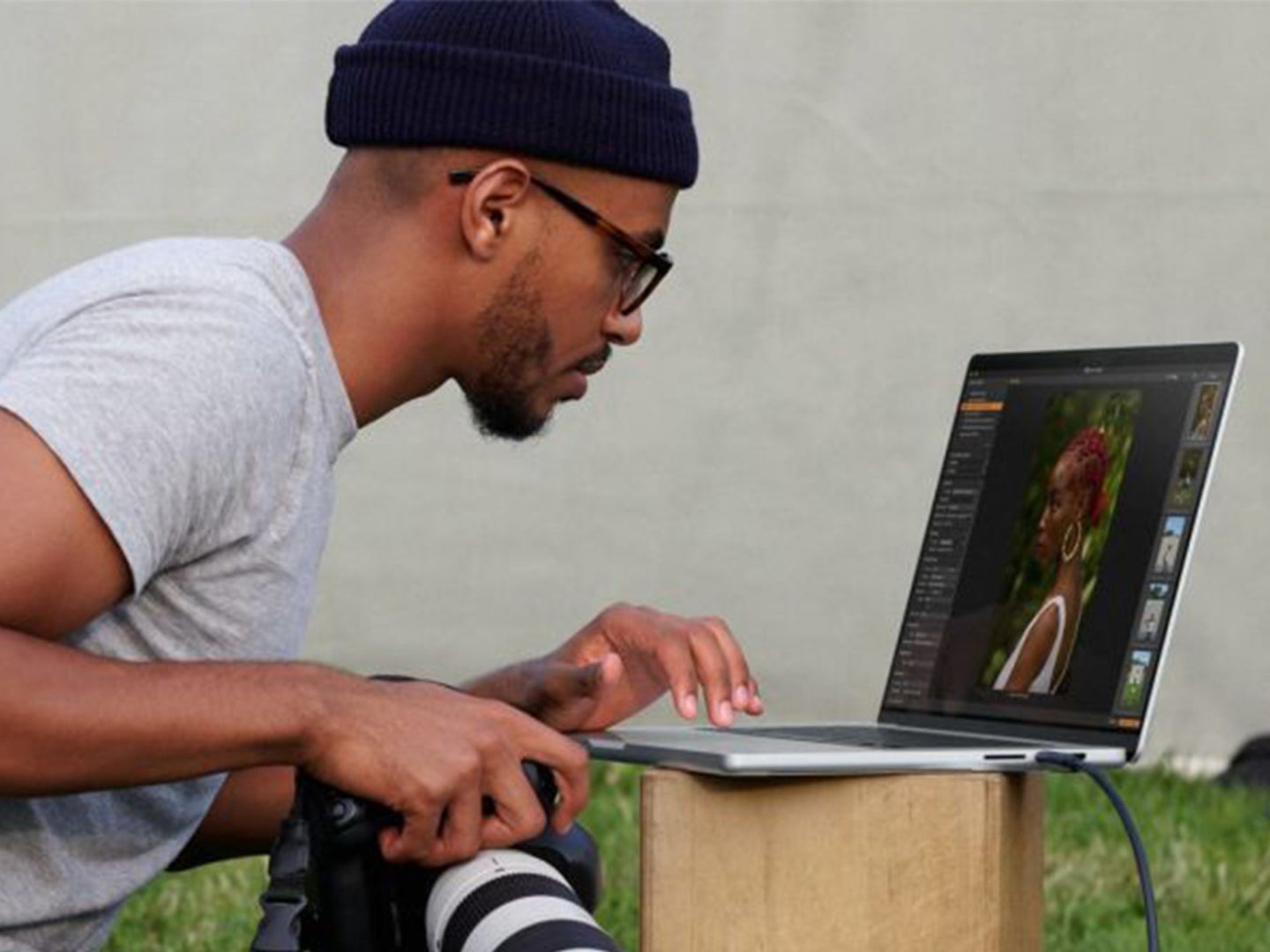 A person using a Macbook to edit a photo.
