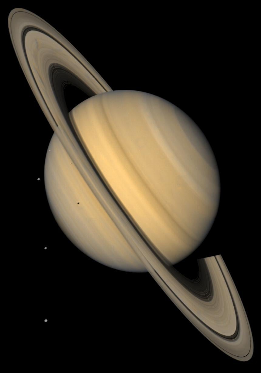Approximate natural-color image shows Saturn, its rings, and four of its icy satellites taken by Voyager 2.