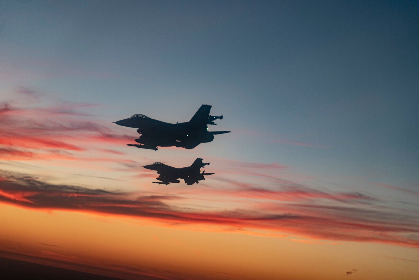 F-16 Fighting Falcons from Eglin Air Force Base fly over a high school football game in Niceville,