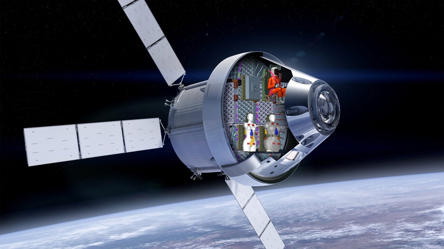Female-shaped mannequins and male-shaped mannequin on Artemis I spacecraft in orbit in mockup